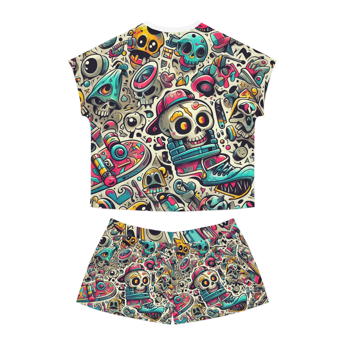 A two-piece women's pyjamas set featuring a short-sleeve crop top and matching shorts, both covered in a colorful, busy graphic print of skulls, sneakers, and musical instruments on a white background.