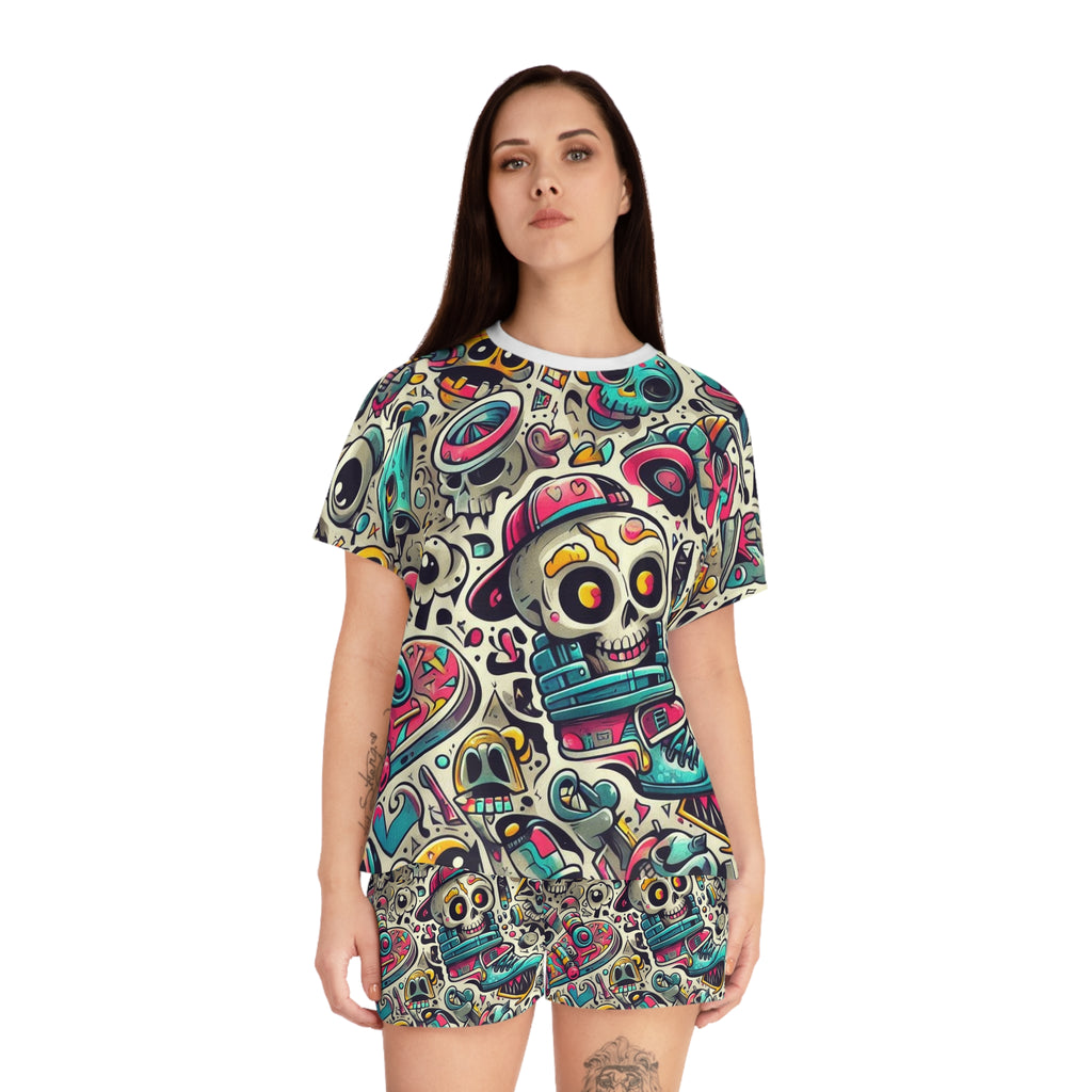 A woman modeling a short-sleeve t-shirt and matching shorts set featuring an all-over colorful Day of the Dead sugar skull pattern on a white background.
