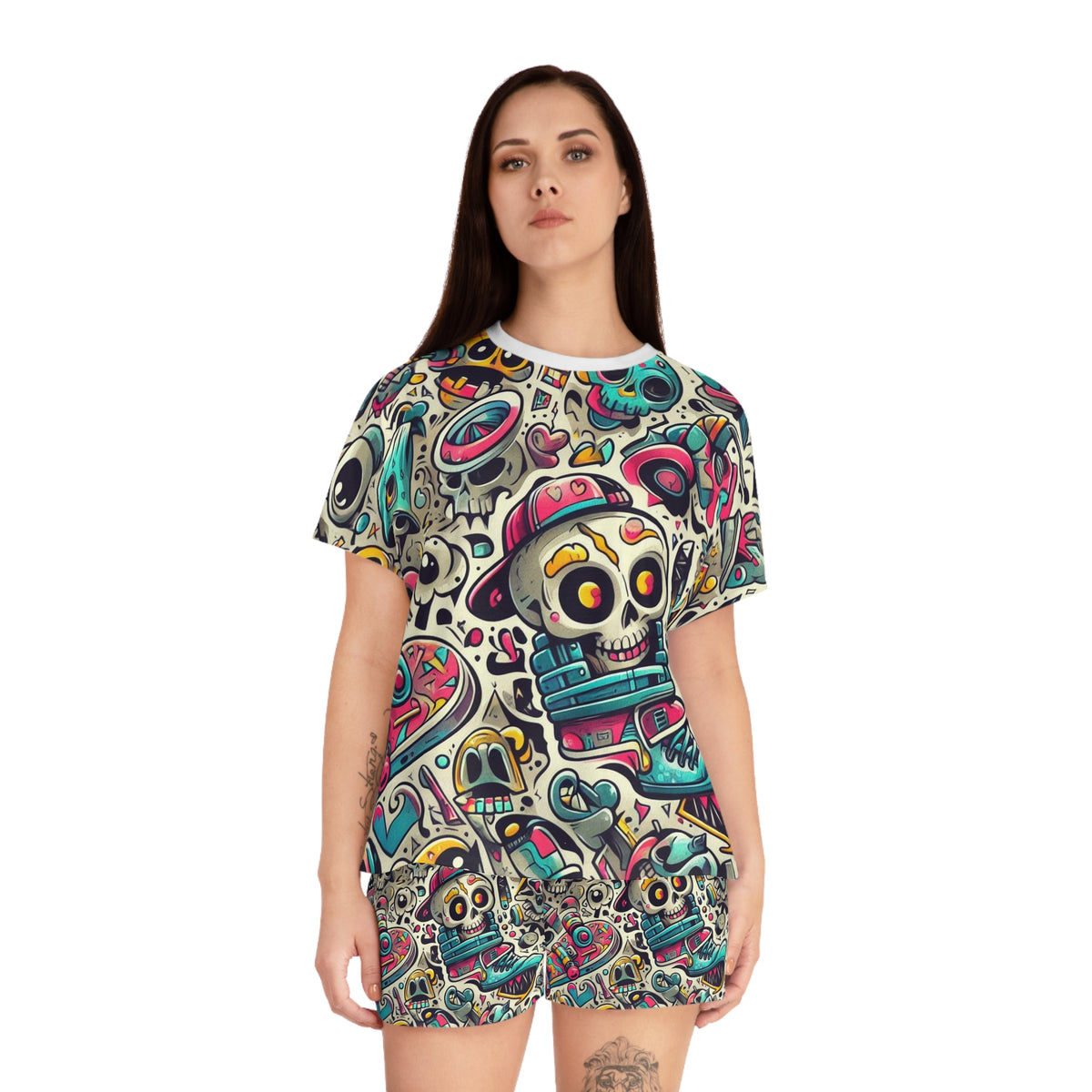A woman modeling a short-sleeve t-shirt and matching shorts set featuring an all-over colorful Day of the Dead sugar skull pattern on a white background.