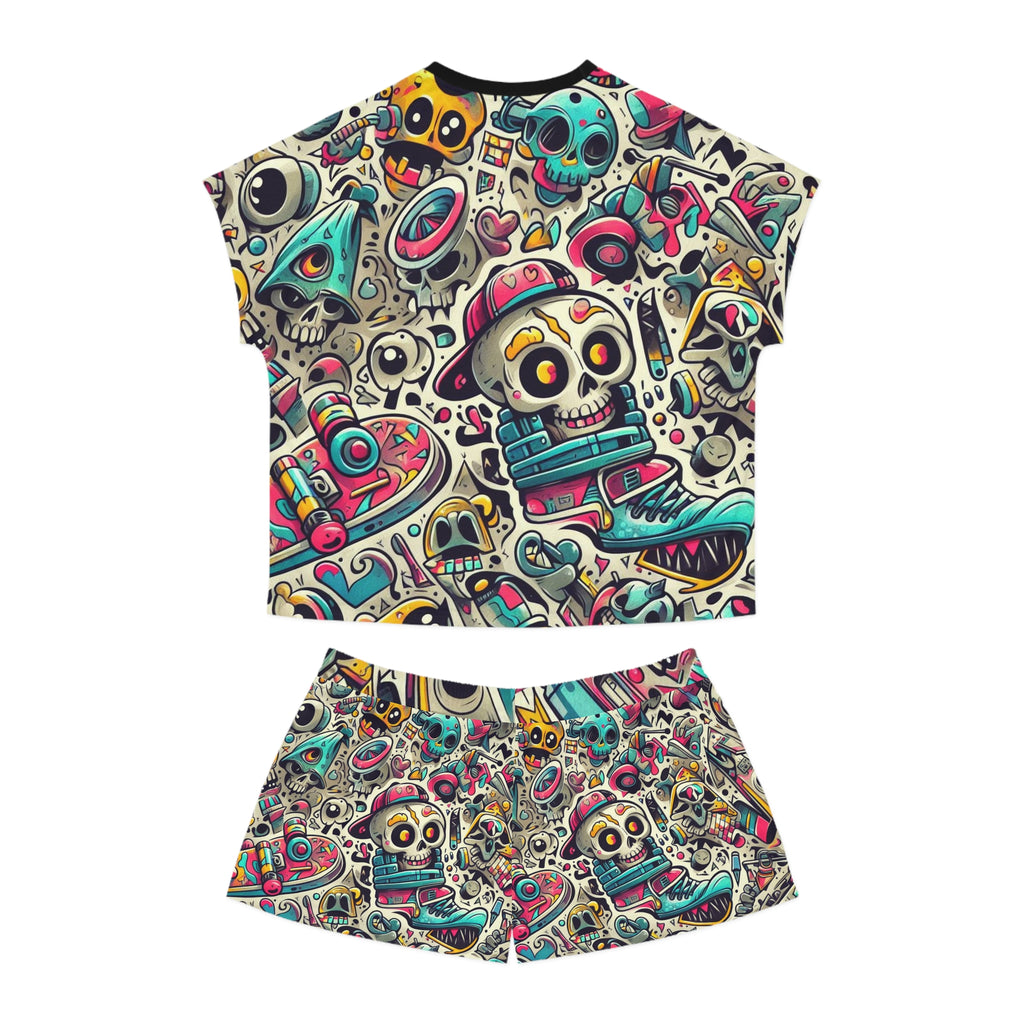 A two-piece matching set featuring a short-sleeve crop top and shorts with an all-over colorful cartoon skull and graffiti-style pattern on a white background.