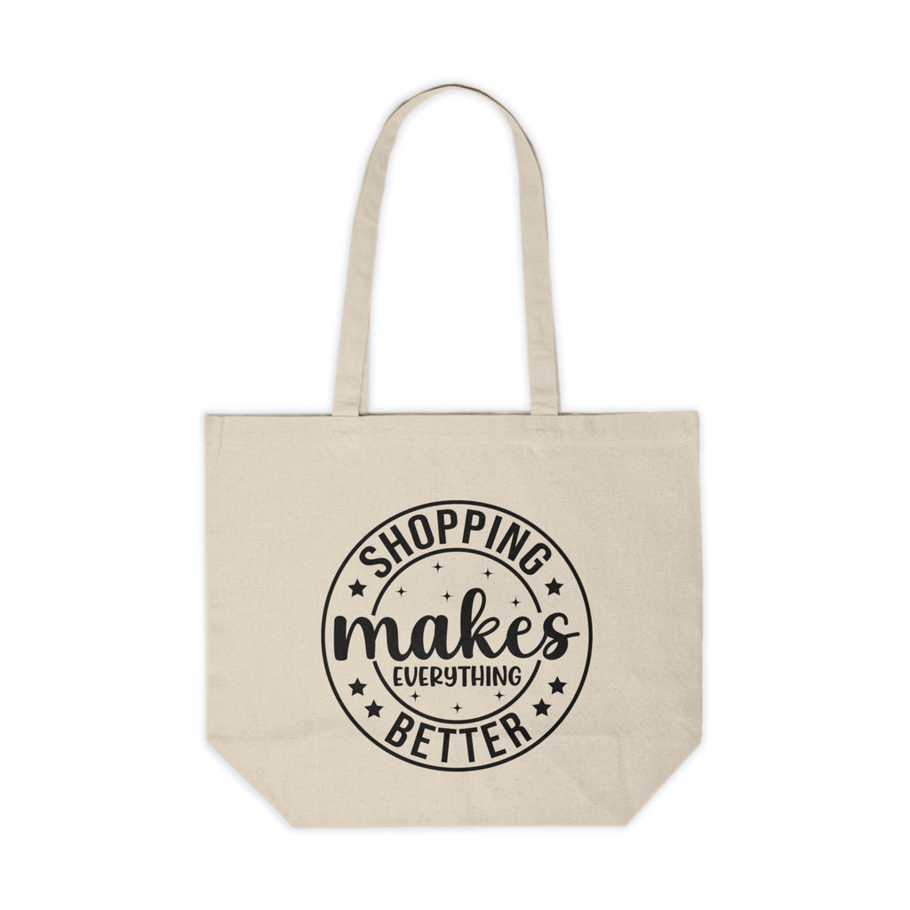 Beige tote bag with 'Shopping makes everything better' text on a white background