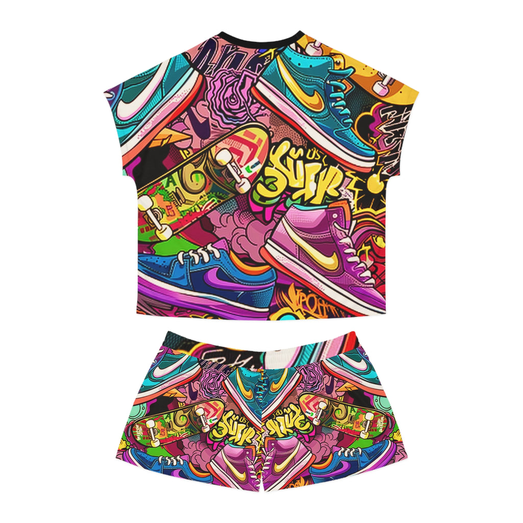 A two-piece matching set featuring a short-sleeve crop top and shorts with a vibrant, multicolor graffiti-style graphic print. The design is a detailed collage of various Nike sneakers in bright colors like purple, blue, pink, green, and yellow, overlaid with graffiti text and street art elements, shown against a plain white background.
