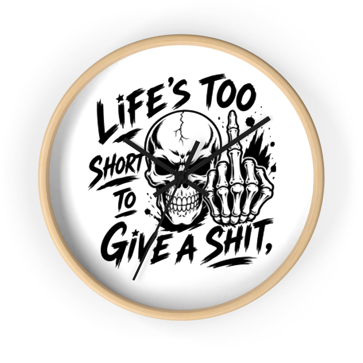 A round wall clock with a light natural wood frame and a white face, featuring a bold black graphic of a skull and skeletal hand making a middle finger gesture, with the text 'LIFE'S TOO SHORT TO GIVE A SHIT,' on a clean white background.