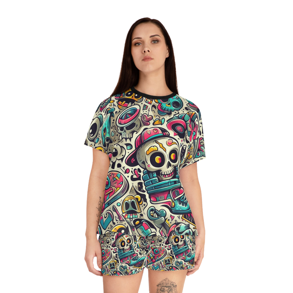 A woman modeling a short-sleeve t-shirt dress with an all-over colorful Day of the Dead sugar skull pattern on a white background.