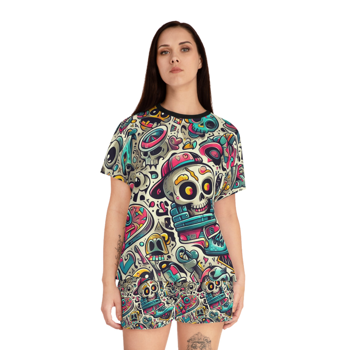 A woman modeling a short-sleeve t-shirt dress with an all-over colorful Day of the Dead sugar skull pattern on a white background.