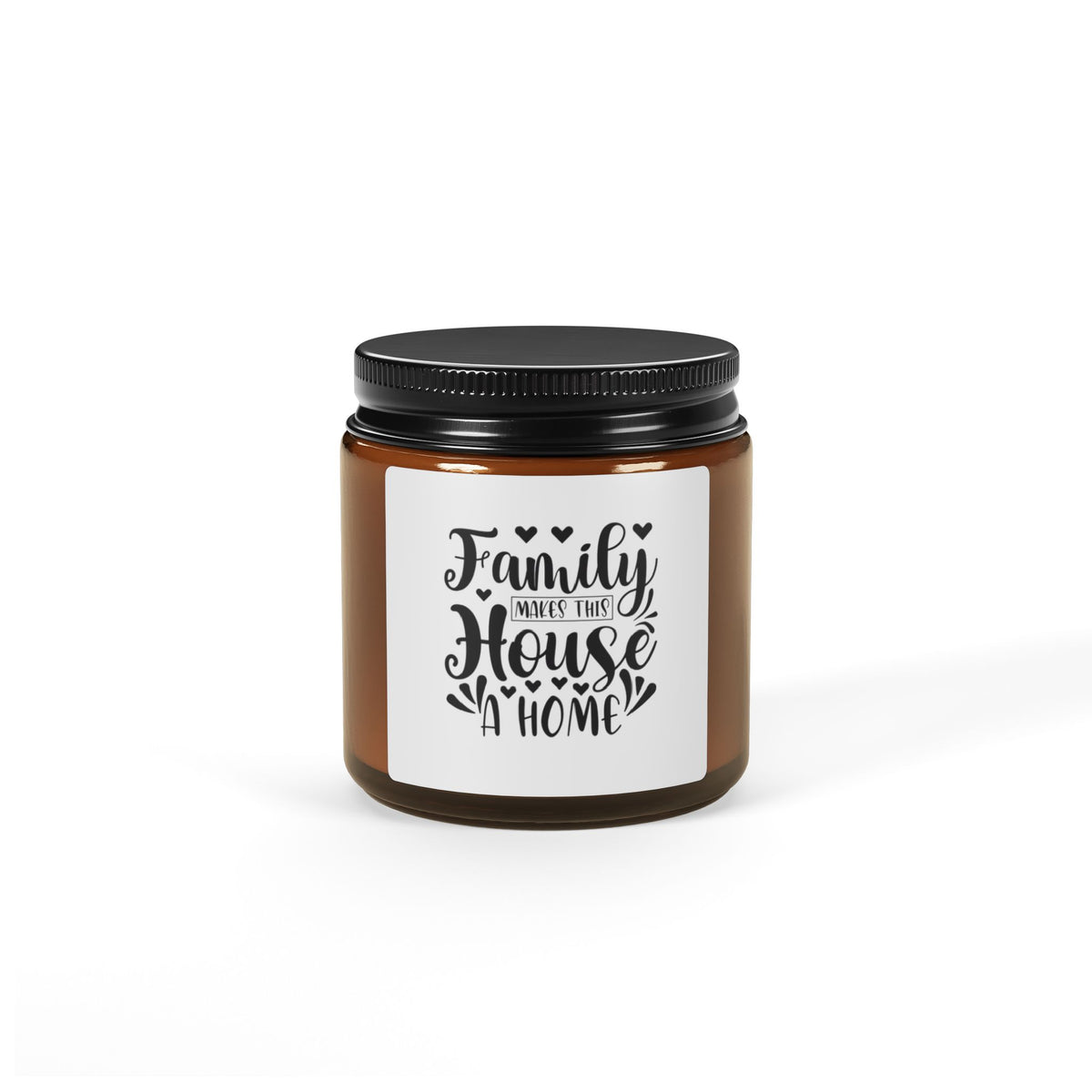 An amber glass jar candle with a black metal lid and a white label that reads 'Family WHEE WHEN THIS House A HOME' in black script, shown on a clean white background.