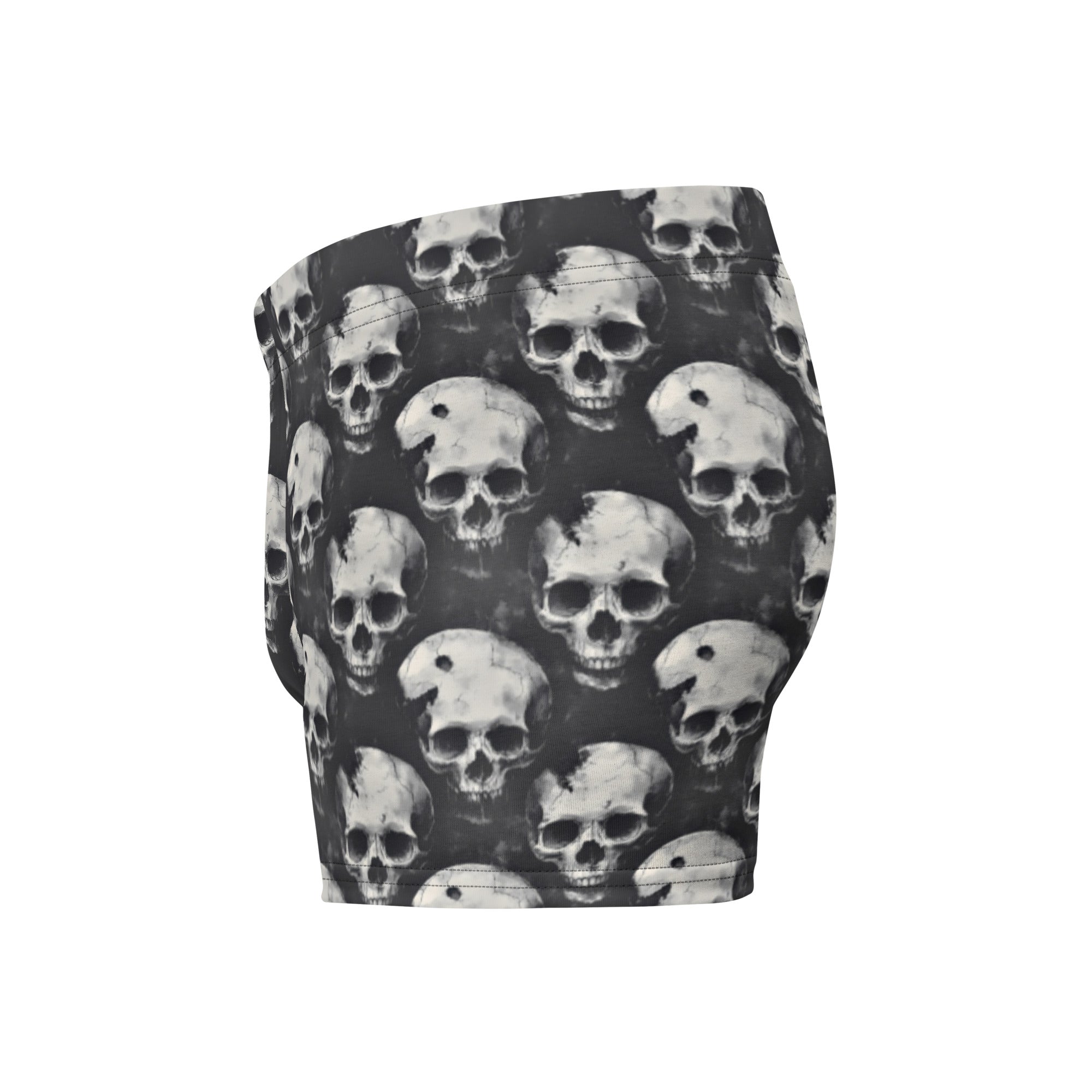 Black and white patterned shorts featuring an all-over repeating skull print, shown against a plain white background.