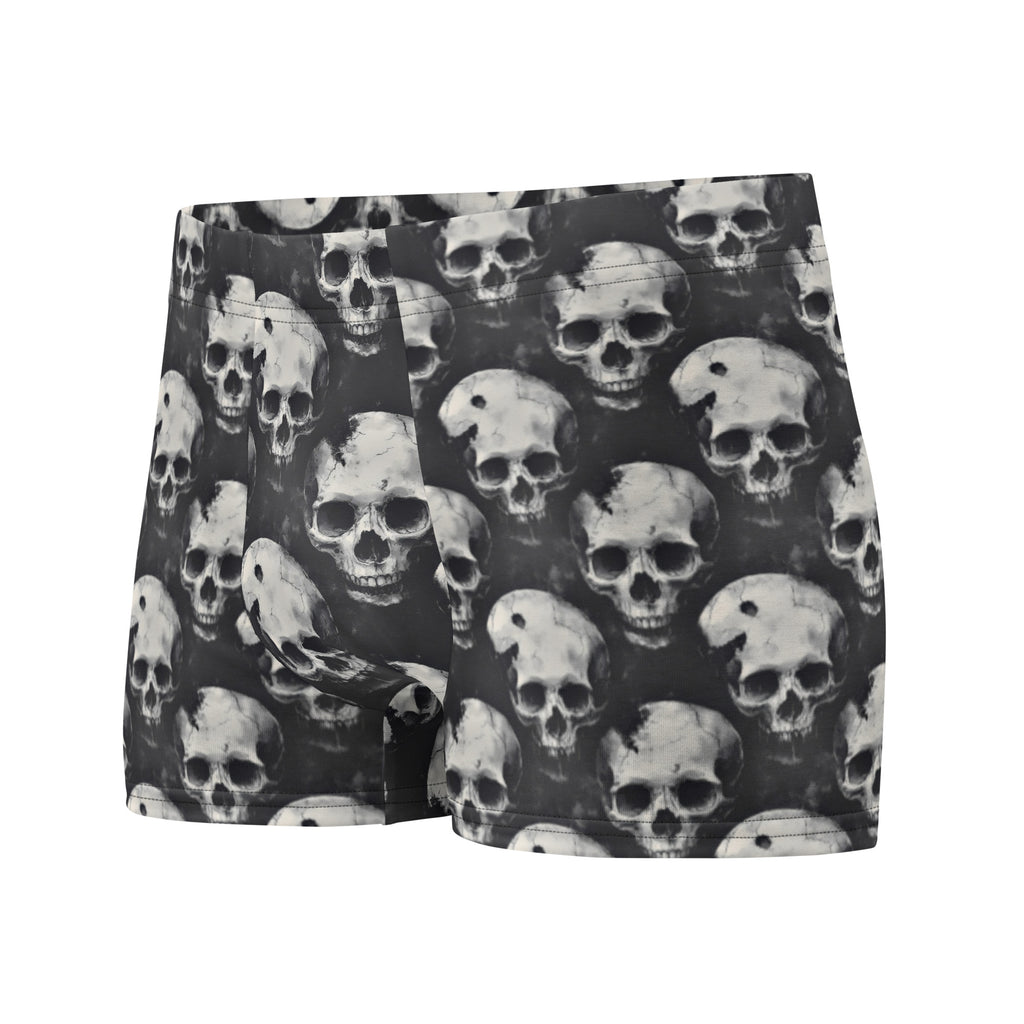 Black boxer briefs featuring an all-over repeating skull print in shades of gray and white, shown against a plain white background.