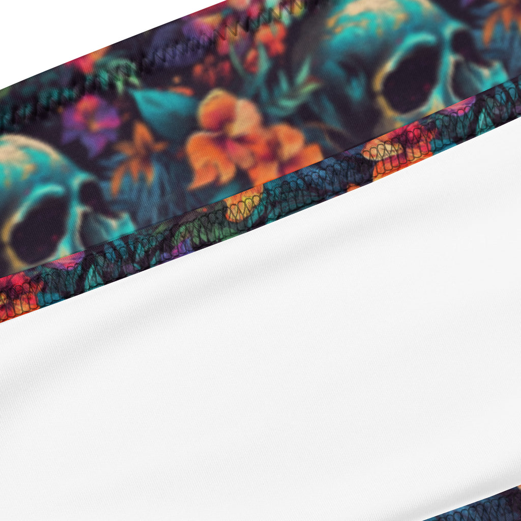 Close-up of a fabric product with a colorful skull and floral print along the edge, shown against a plain white background.