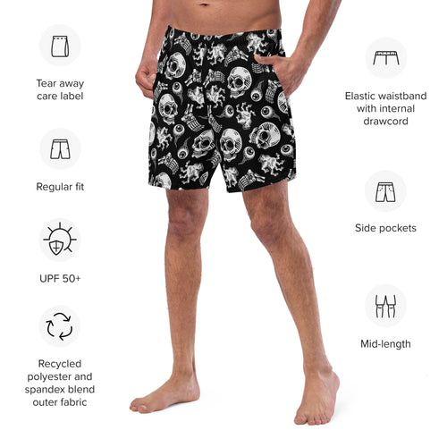 Person wearing black swim shorts with white patterns on a white background, featuring product details.