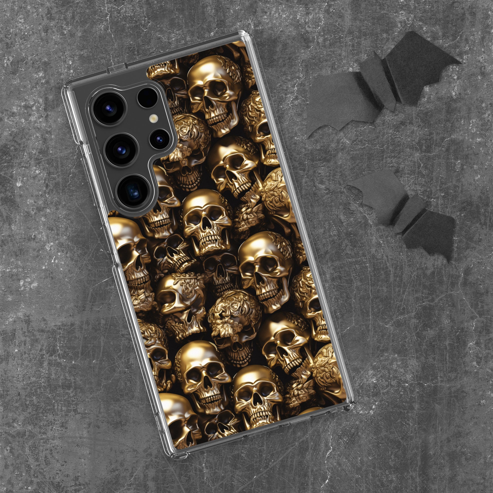 Phone case with gold skull design on a gray background
