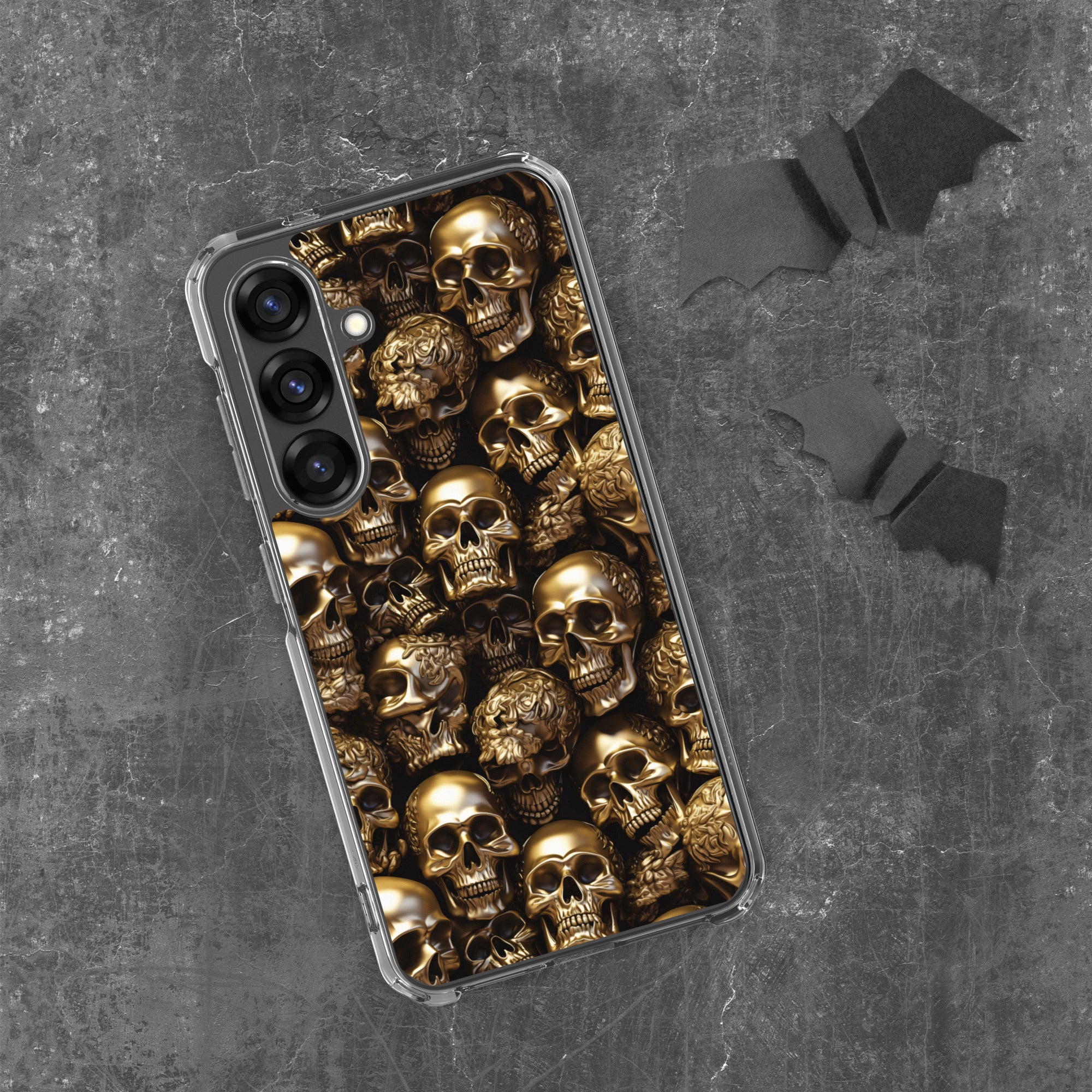 Phone case with gold skull design on a dark gray background