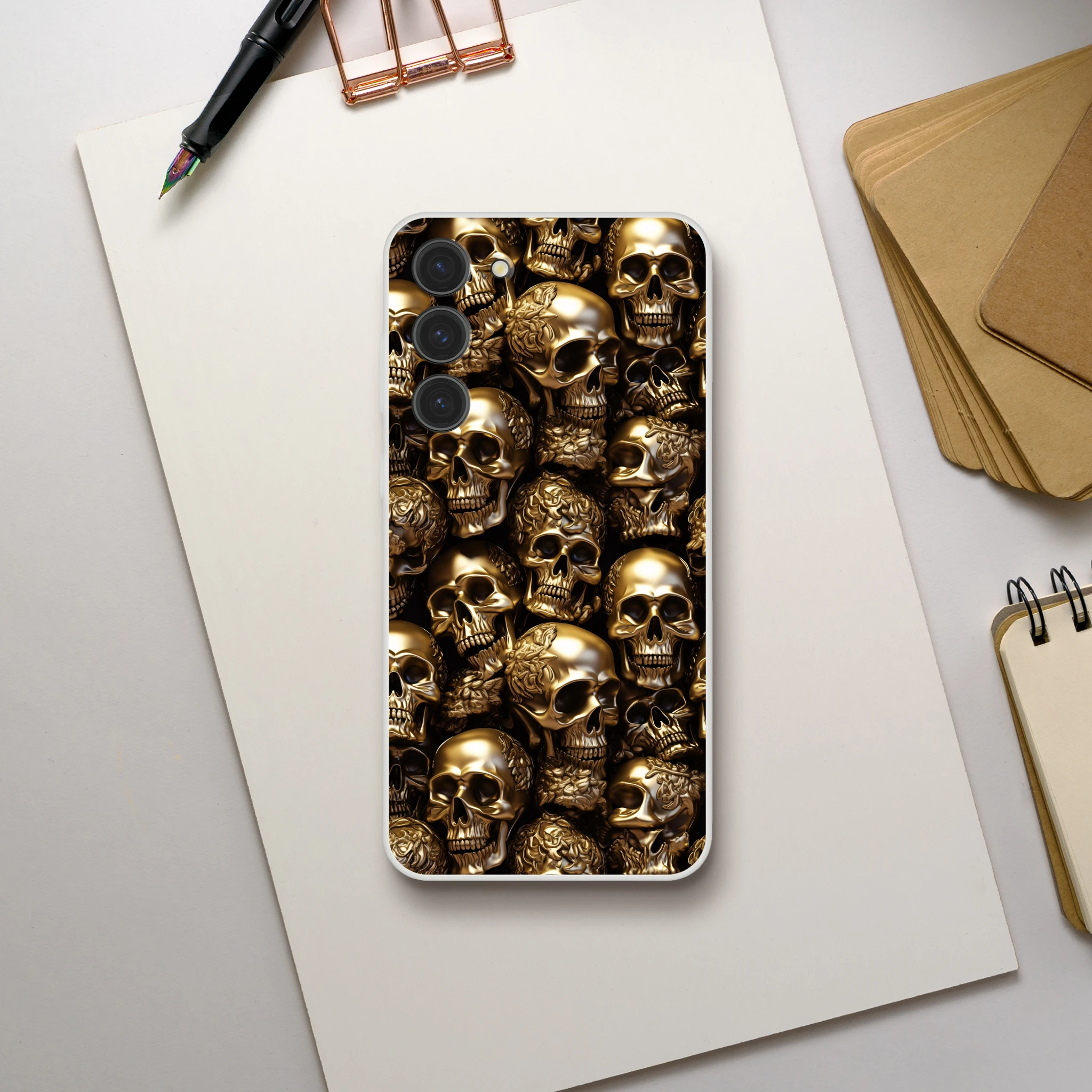 Phone case with gold skull design on a white surface 1