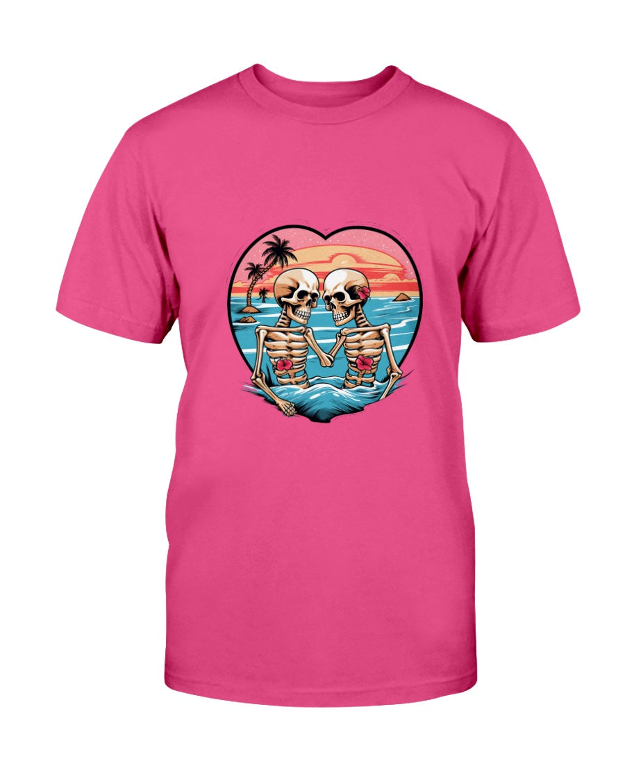 Pink t-shirt with a graphic of two skeletons holding hands on a beach, set against a heart-shaped sky.