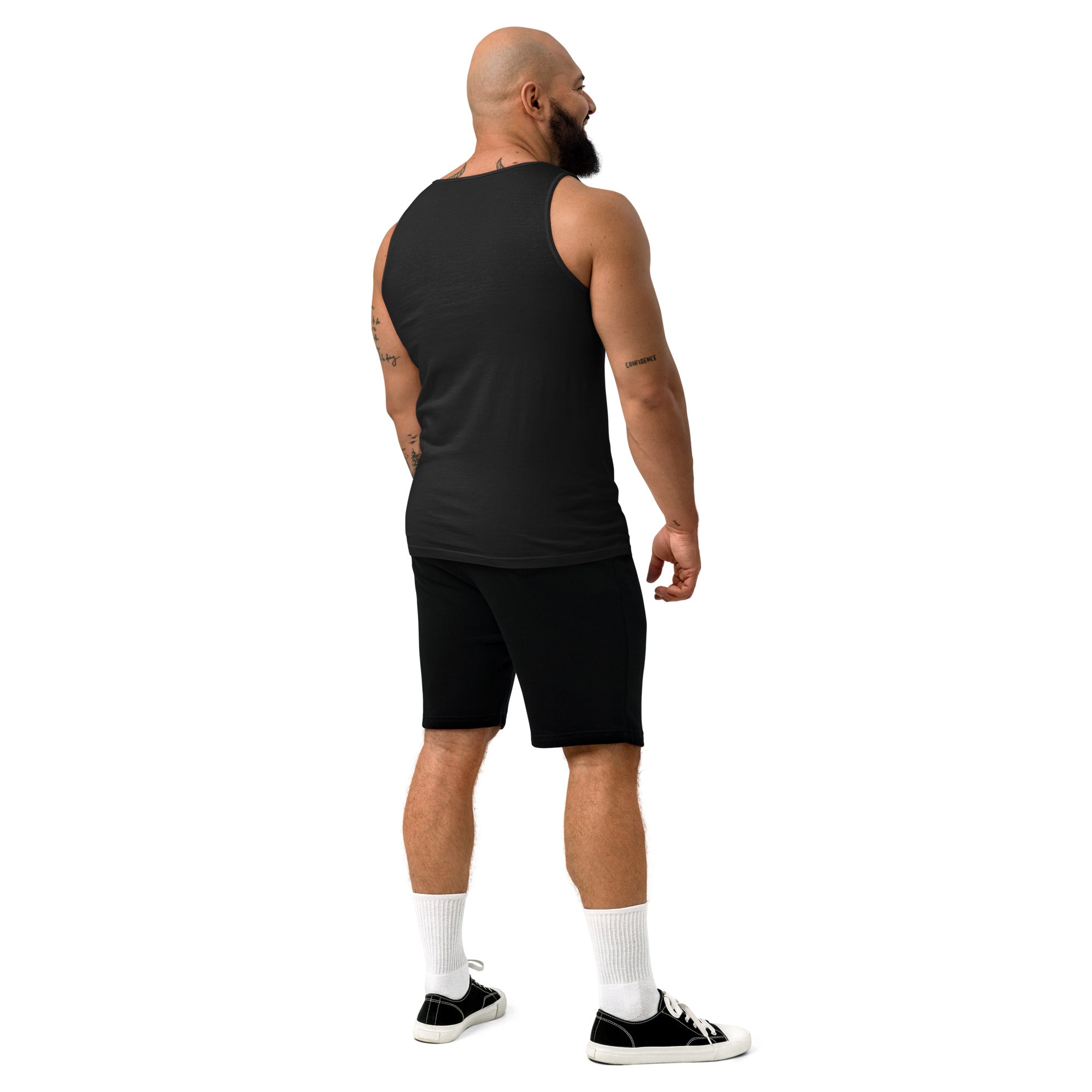 Man wearing a black tank top and shorts on a white background