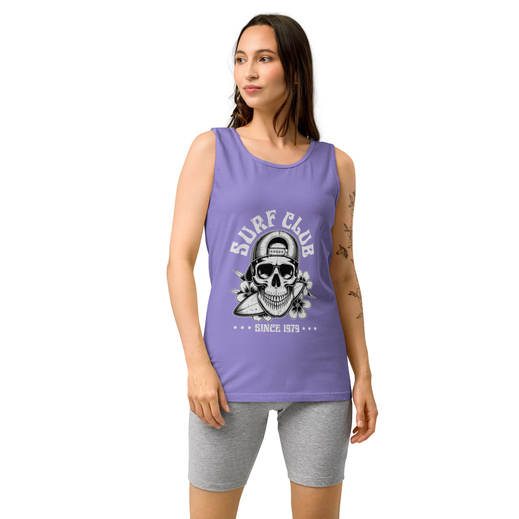 A woman modeling a lavender purple sleeveless tank top with a skull with saying surf club on the front, paired with gray heather biker shorts against a plain white background.