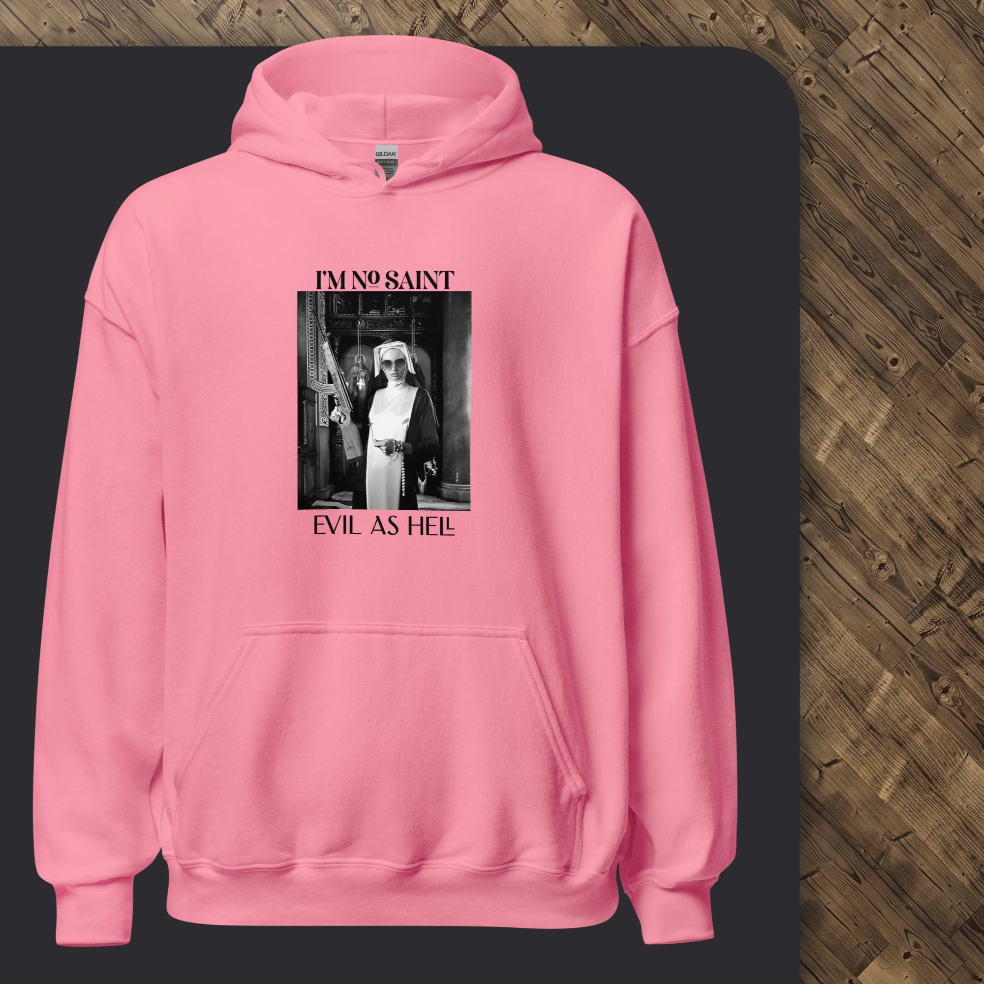 Pink hoodie with graphic design on a dark surface