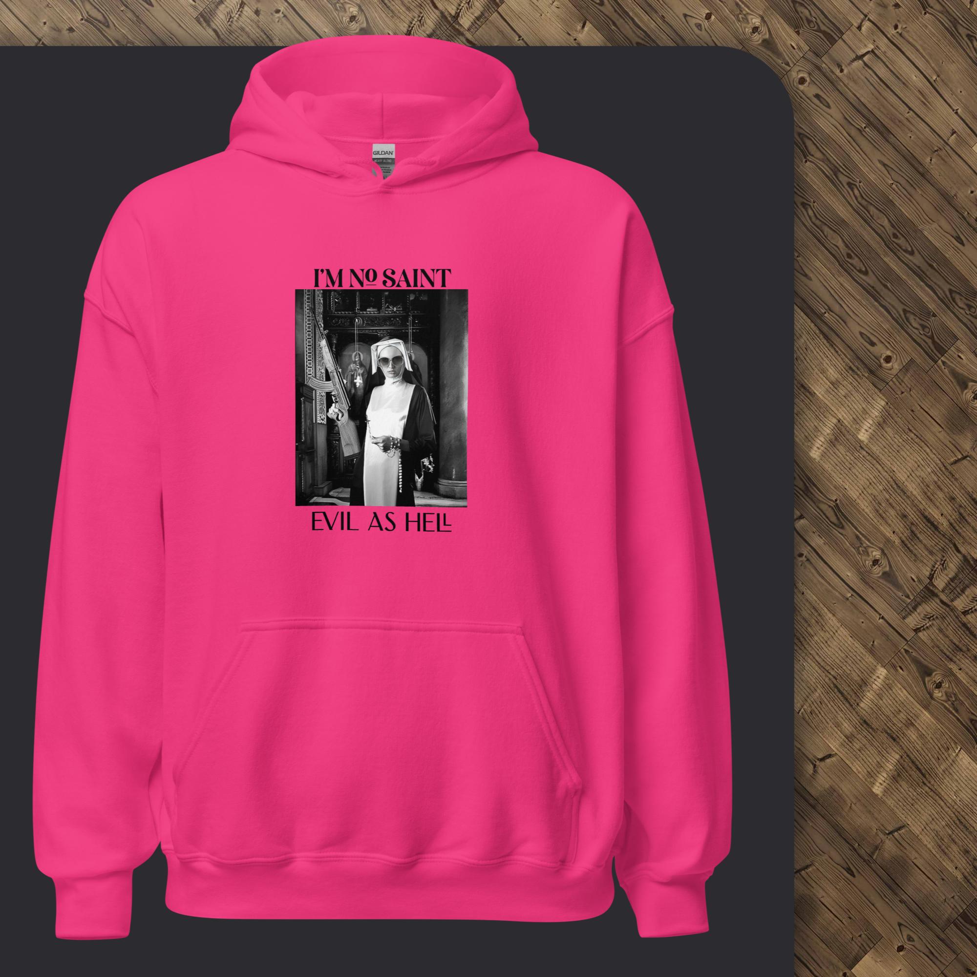 Pink hoodie with graphic design and text on a wooden floor background