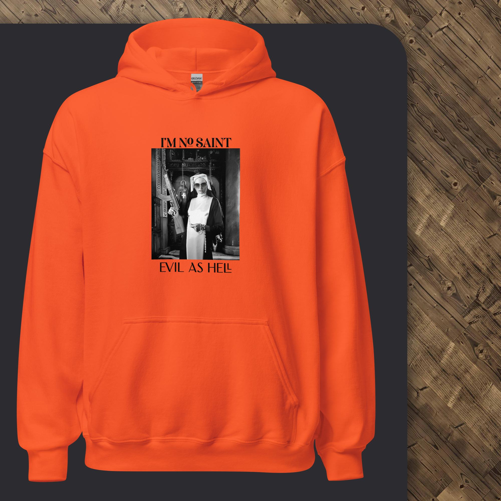 Orange hoodie with graphic design on a dark surface